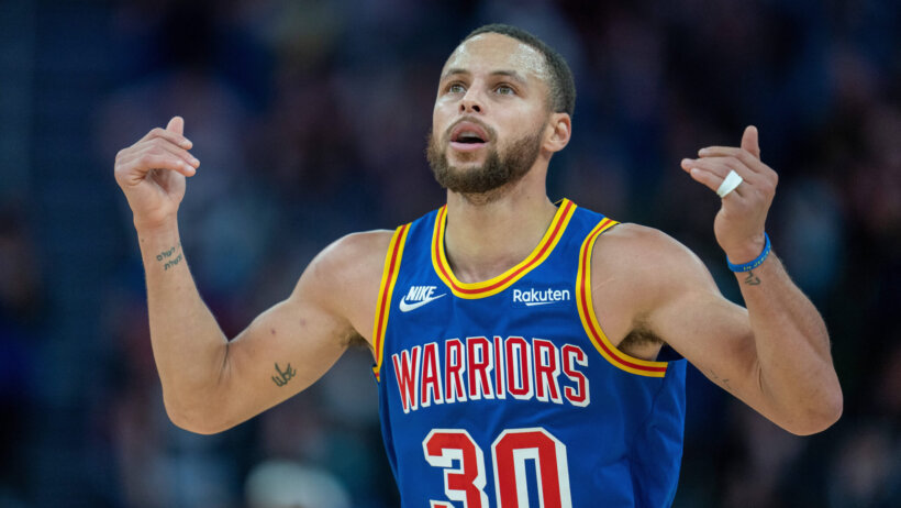 Steph Curry arms up and out celebrating