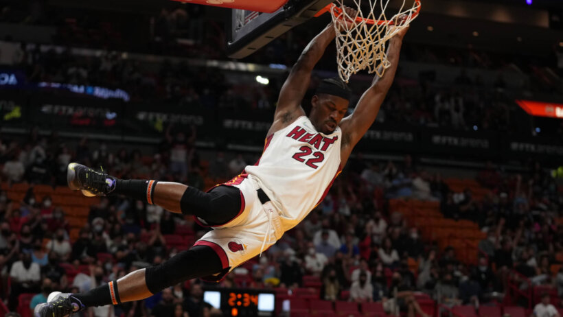 Jimmy Butler hanging on rim after dunk