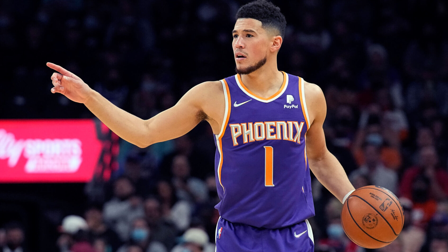 Devin Booker dribbling and pointing