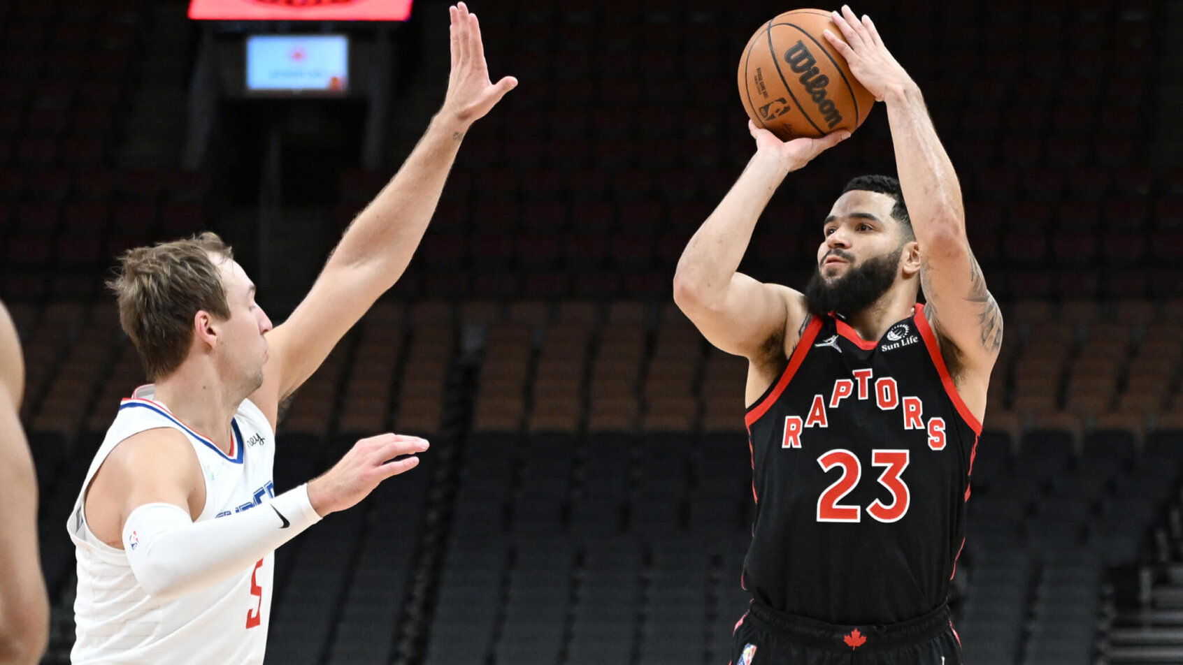 Fred VanVleet shooting the ball over Luke Kennard during an NBA game.