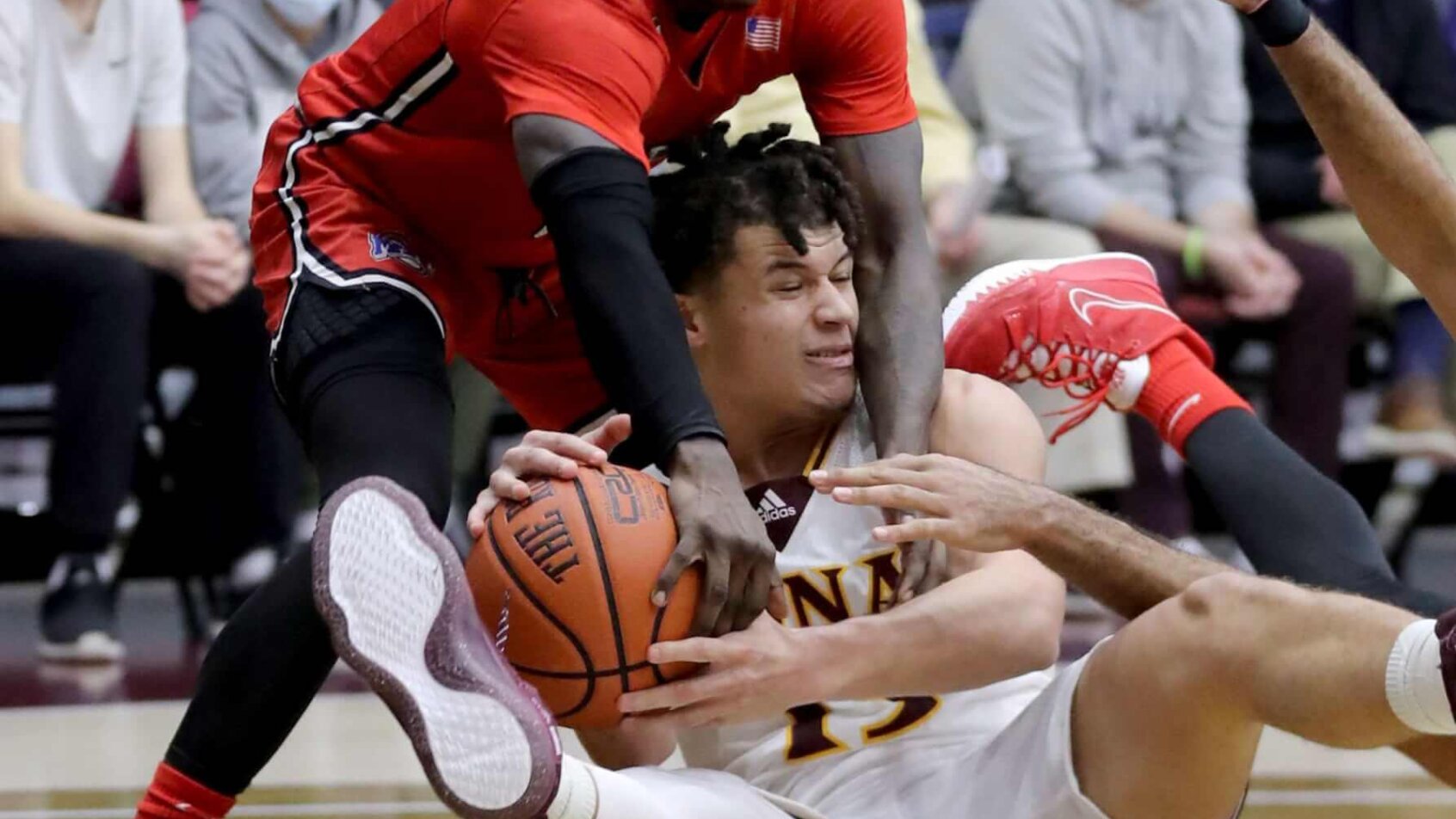 Iona's Walter Clayton, Jr wrestles for a loose ball