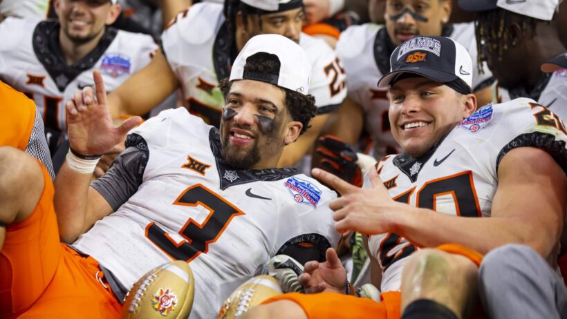 Oklahoma State Cowboys quarterback Spencer Sanders and linebacker Malcolm Rodriguez celebrate winning the Fiesta Bowl over Notre Dame