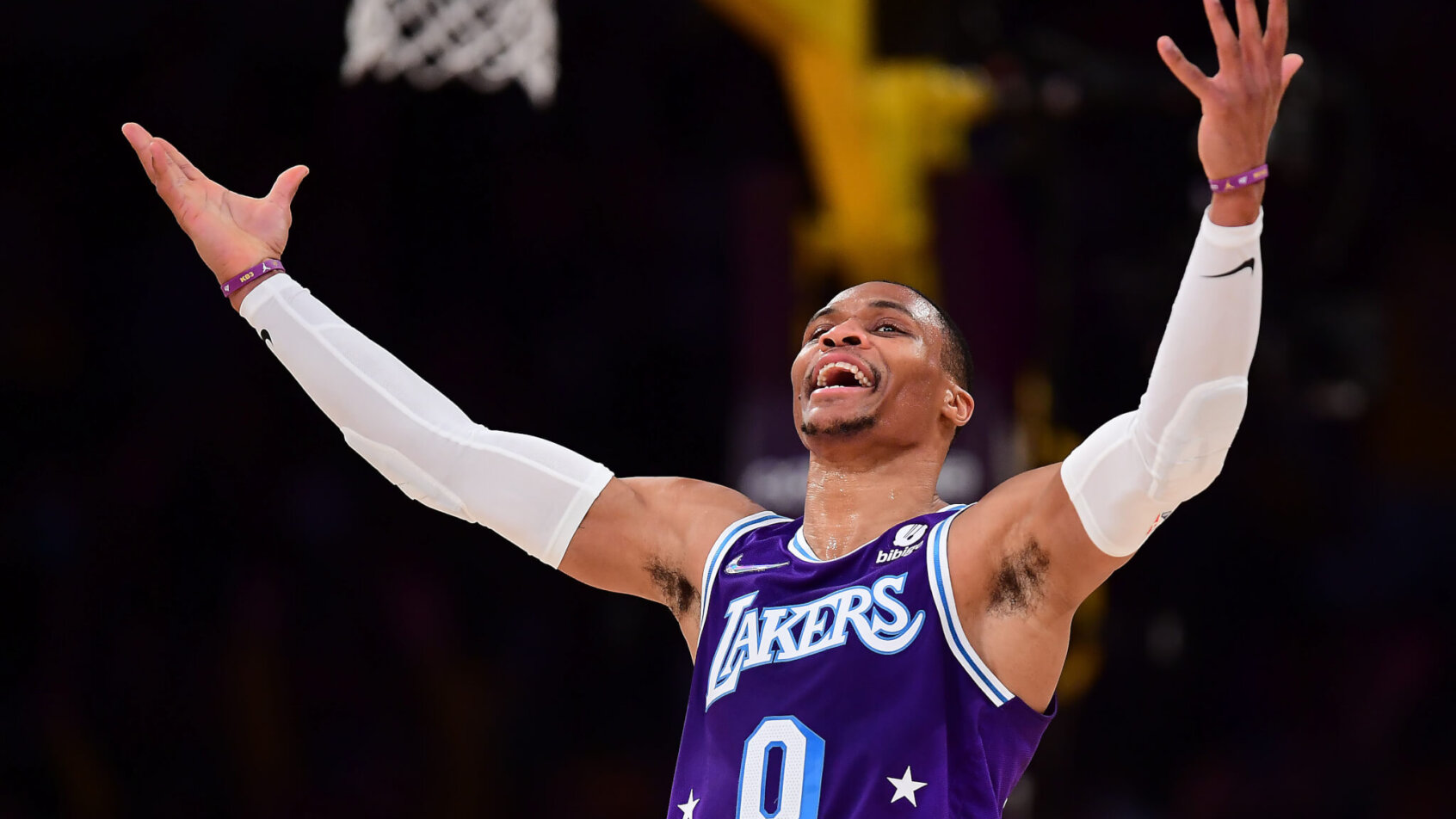 Russell Westbrook throws arms up in relief after making shot