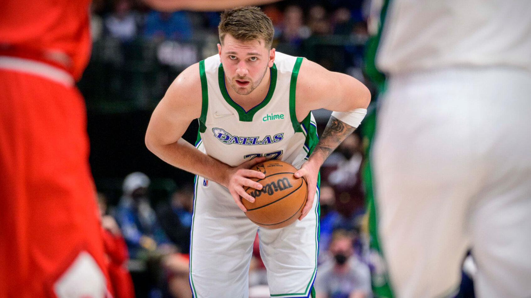 Luka Doncic holding ball top of the key