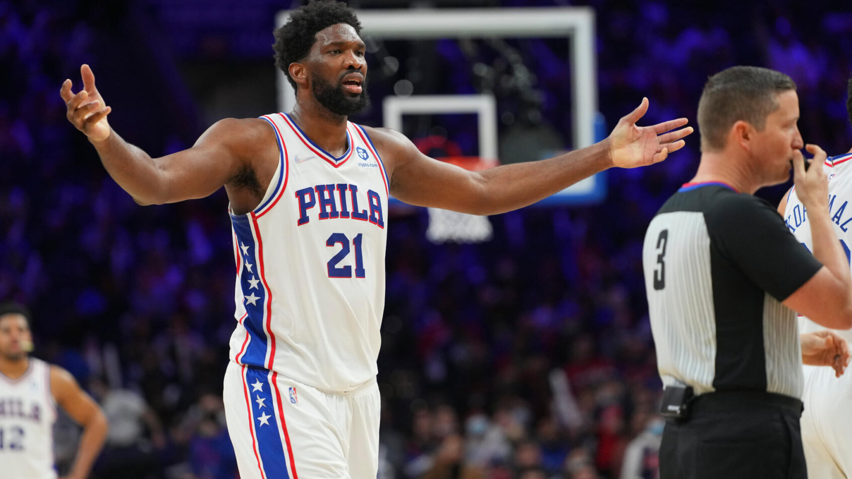 Joel Embiid arms out reaction to a referee call