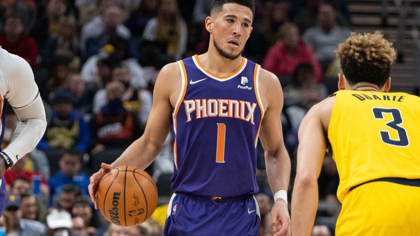 Devin Booker brings the ball up the court