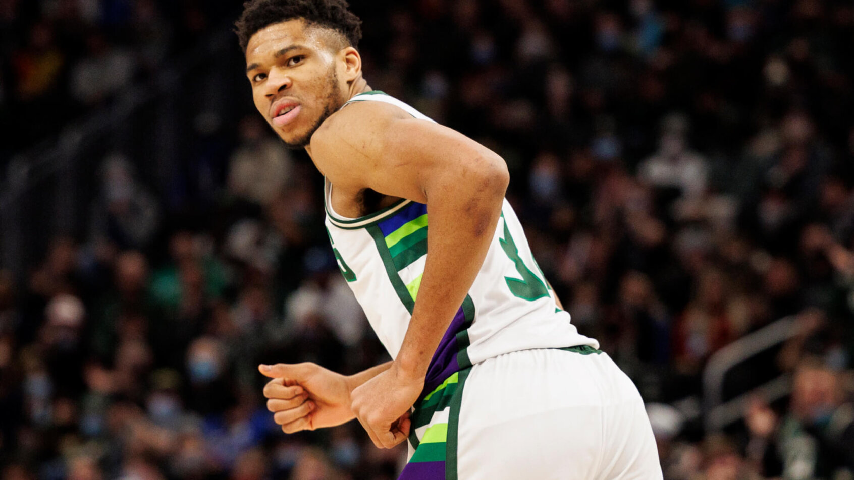 Giannis Antetokounmpo looking back while running