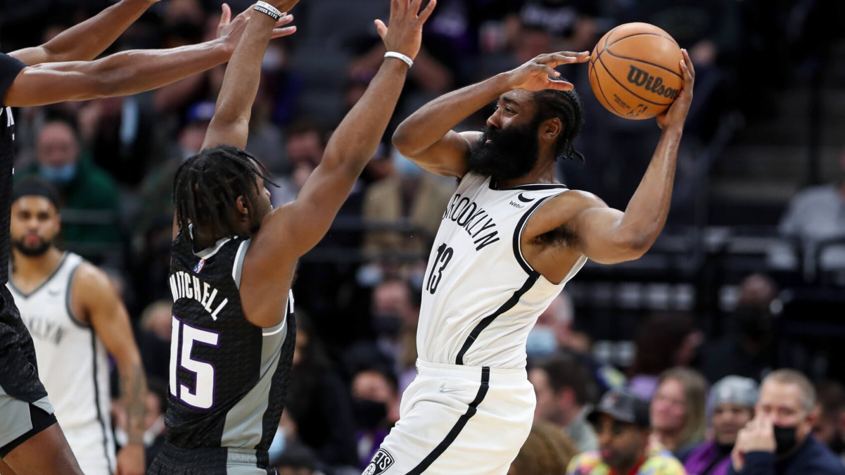 Brooklyn Nets guard James Harden driving to the basket against Sacramento Kings players.