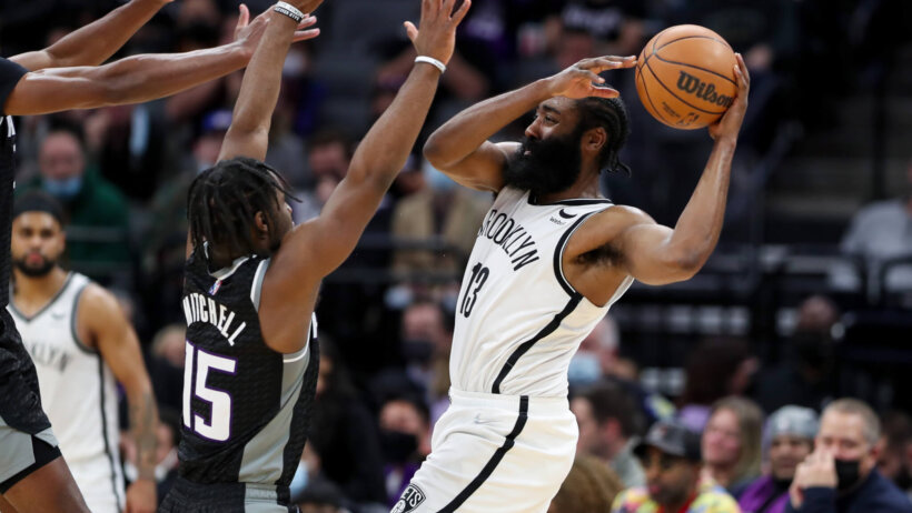 Brooklyn Nets guard James Harden driving to the basket against Sacramento Kings players.