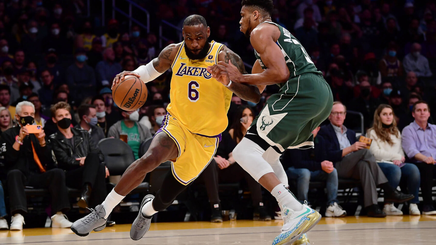Lebron James driving to the basket against Giannis Antetokounmpo during an NBA basketball game.