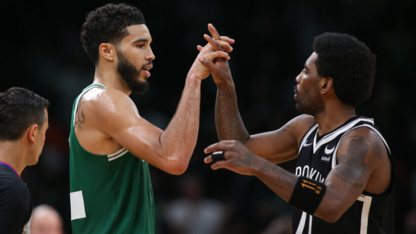 Jayson Tatum and Kyrie Irving high five each other