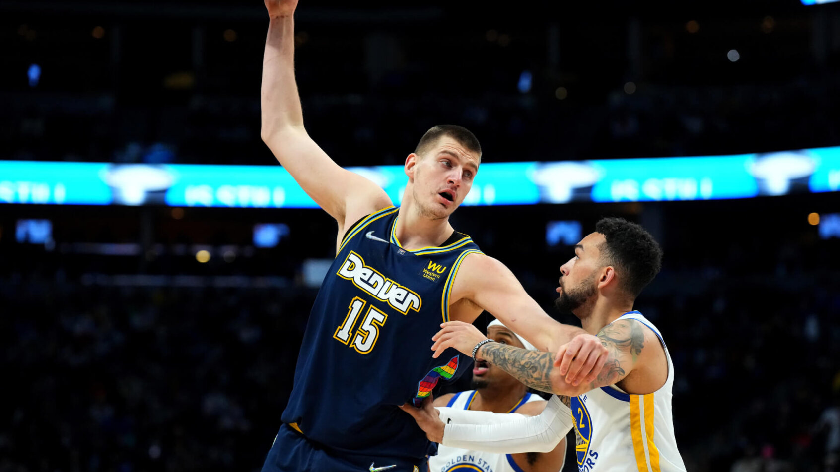 Nikola Jokic posts up against the Warriors