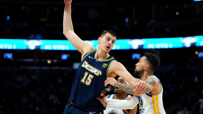 Nikola Jokic posts up against the Warriors