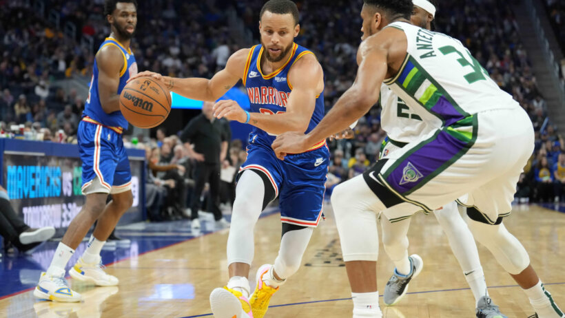 Steph Curry drives against Giannis Antetokounmpo