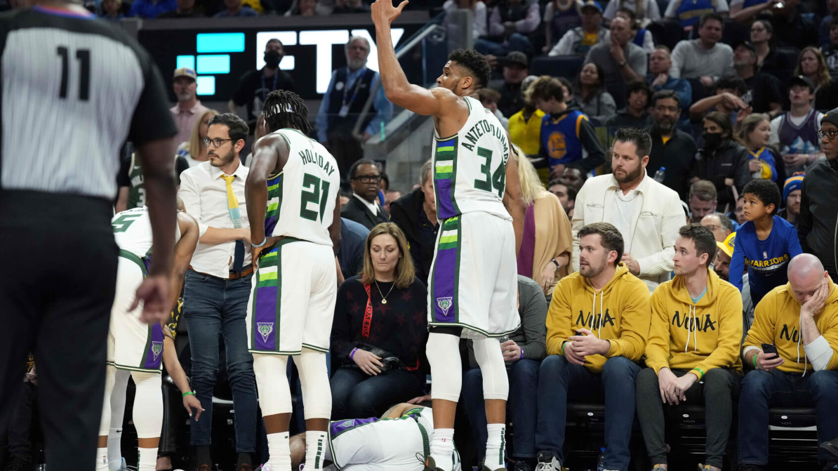 Giannis Antetokounmpo high-fiving teammates
