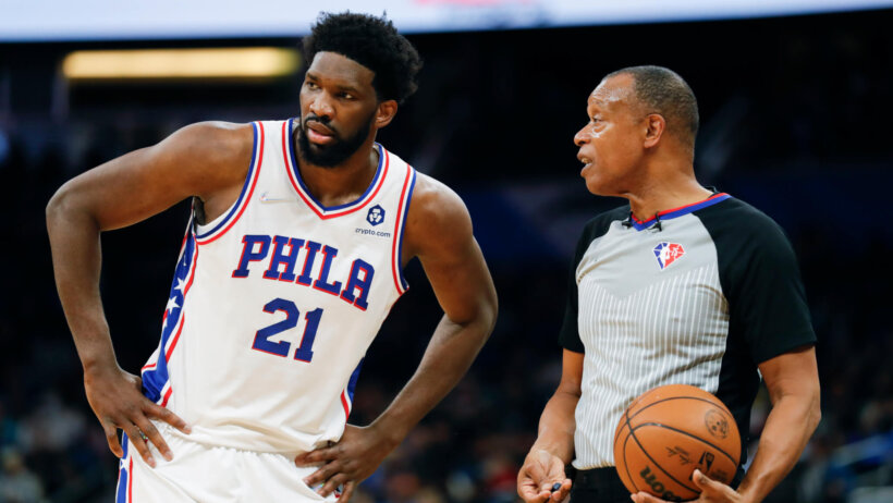 Philadelphia 76ers center Joel Embiid talking to an official