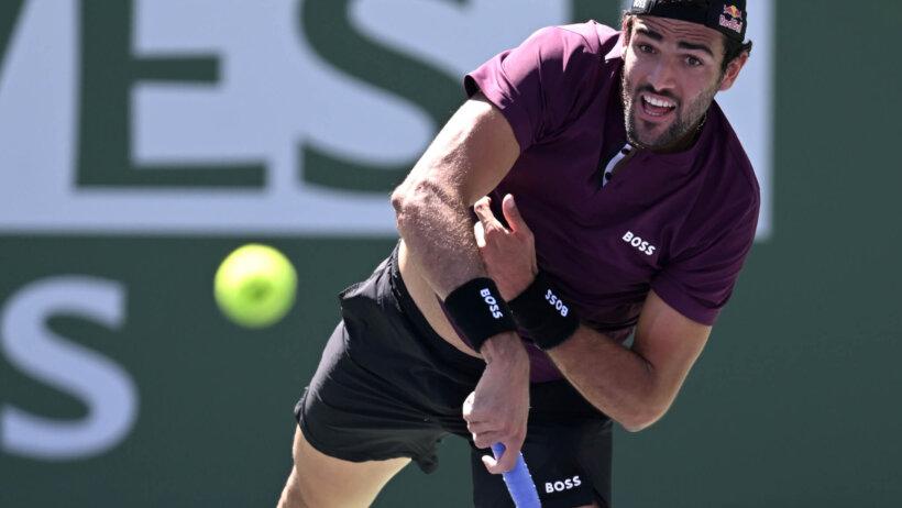 Matteo Berrettini serving the ball during a tennis match.