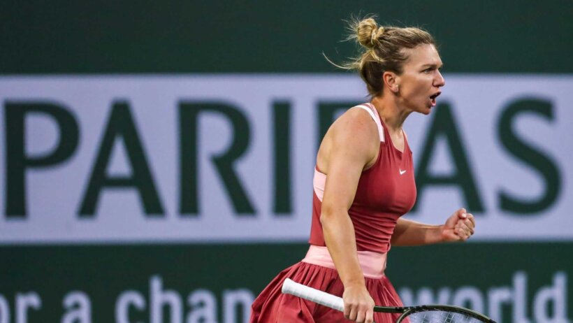Simona Halep reacting with a fist pump after winning a point.