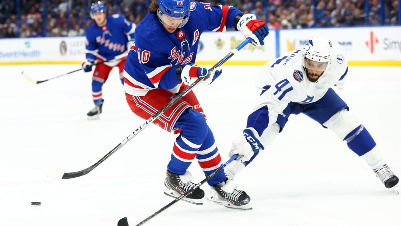 Pierre-Edouard Bellemare and Artemi Panarin battling for the puck