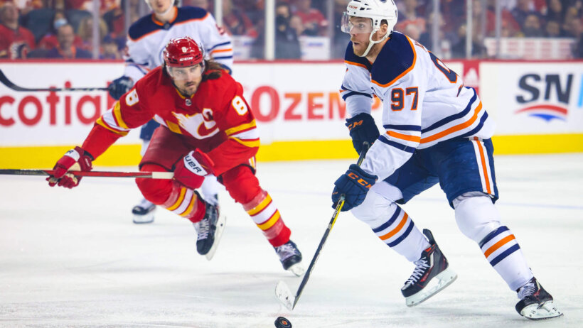 Edmonton Oilers center Connor McDavid carrying the puck up the ice vs Calgary