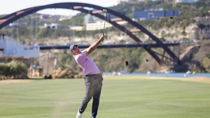 Scottie Scheffler hits a shot from the fairway