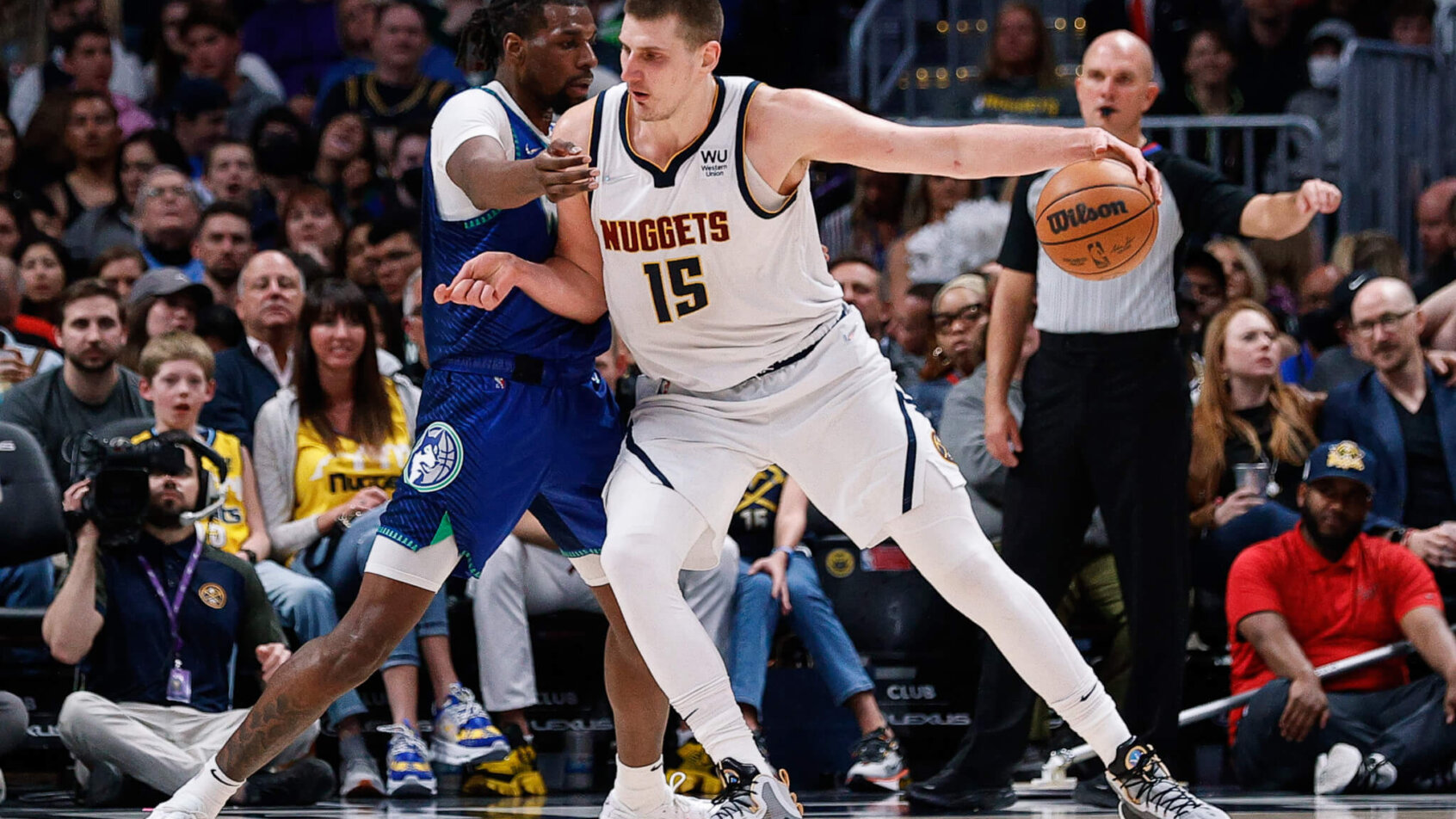Nikola Jokic controlling the ball during an NBA game.