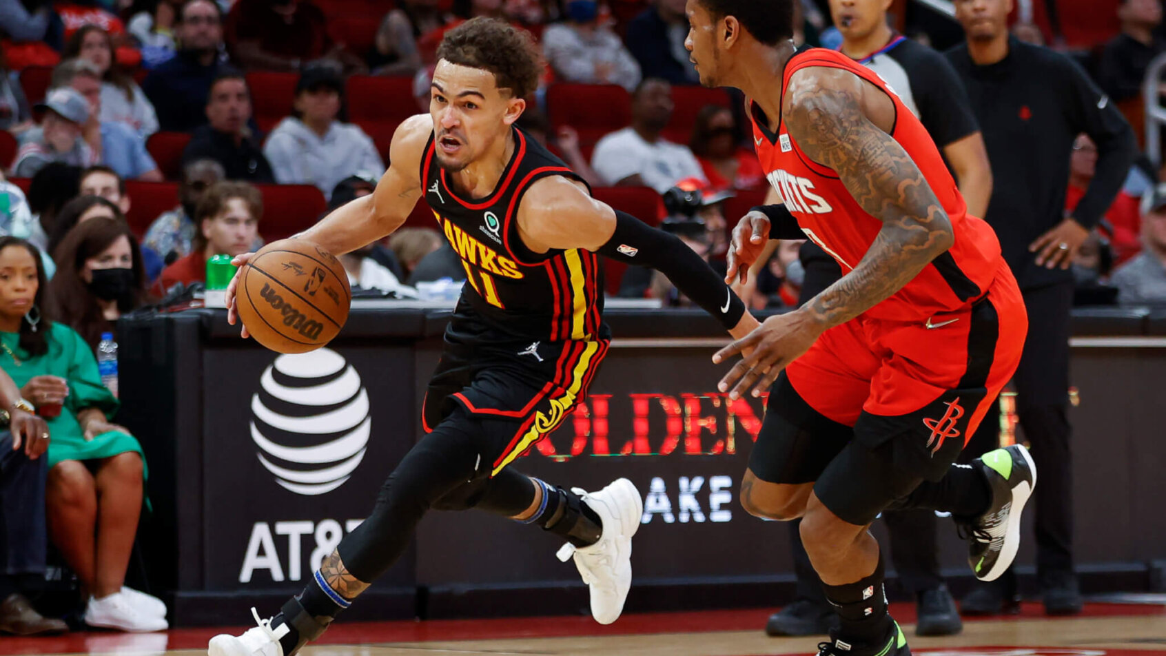 Trae Young driving by defender