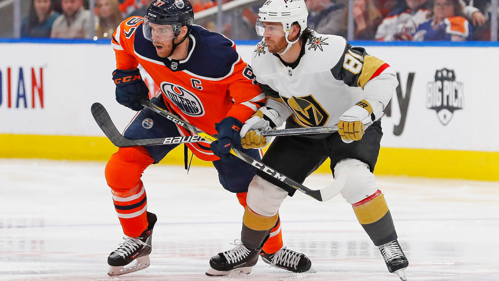 Edmonton Oilers forward Connor McDavid and Vegas Golden Knights forward Jonathan Marchessault battle for a loose puck