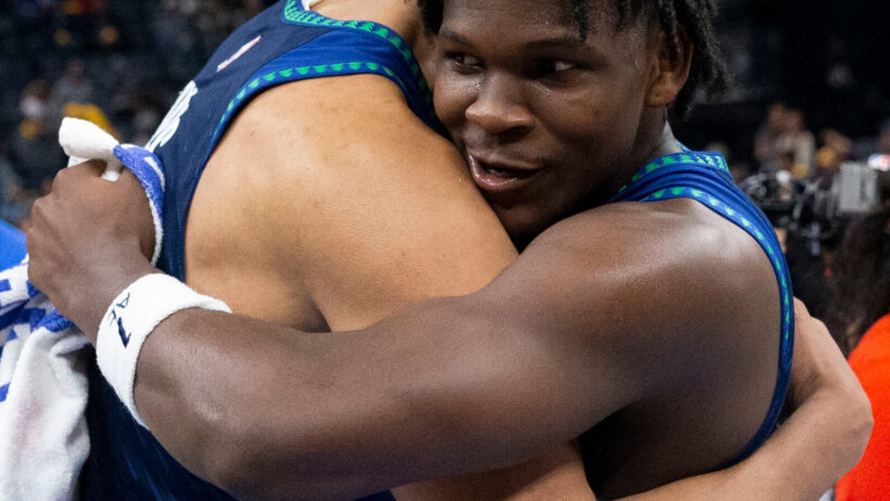 Minnesota Timberwolves center Karl-Anthony Towns and forward Anthony Edwards celebrating a win