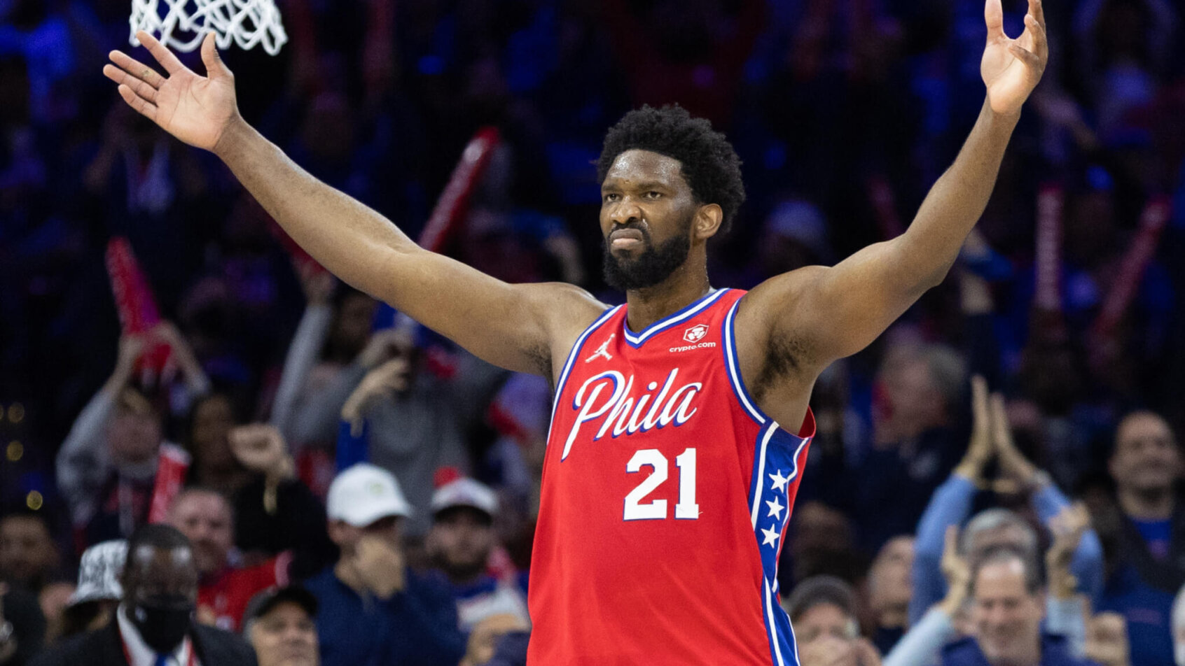 Joel Embiid arms out celebrating