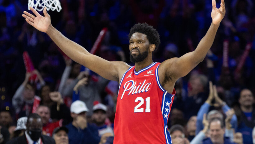 Joel Embiid arms out celebrating