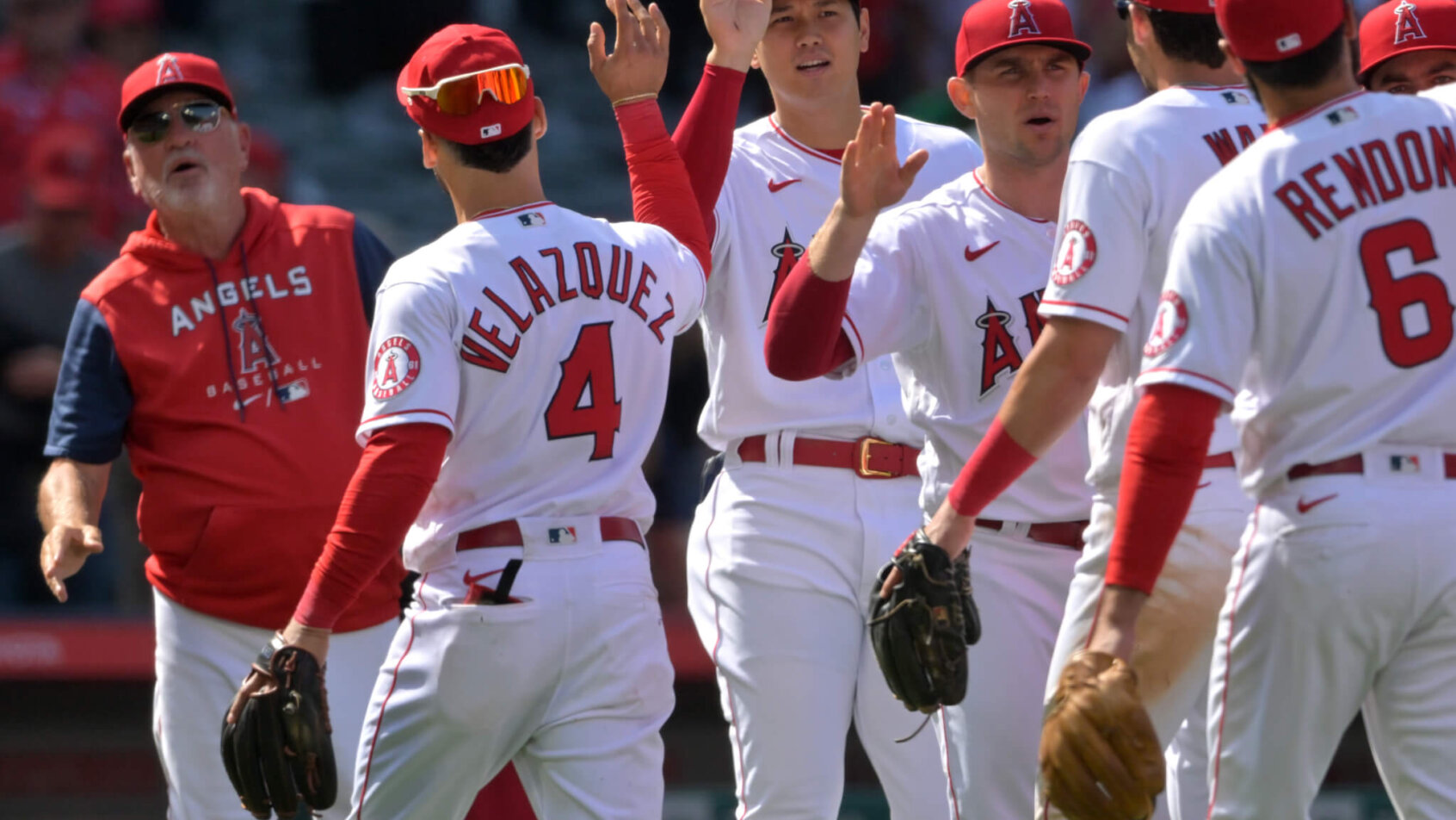 Los Angeles Angels starting pitcher Shohei Ohtani high fiving teammates