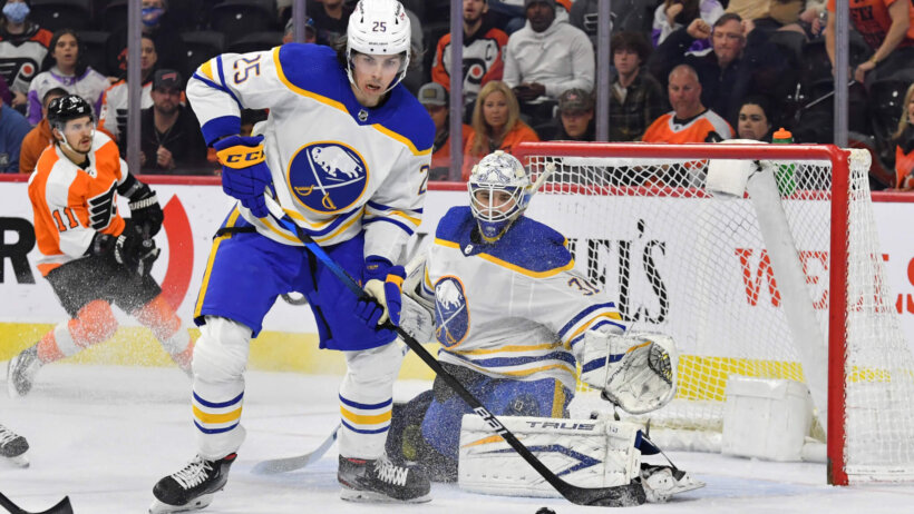 Buffalo Sabres defenseman Owen Power clears the puck from in front of the net