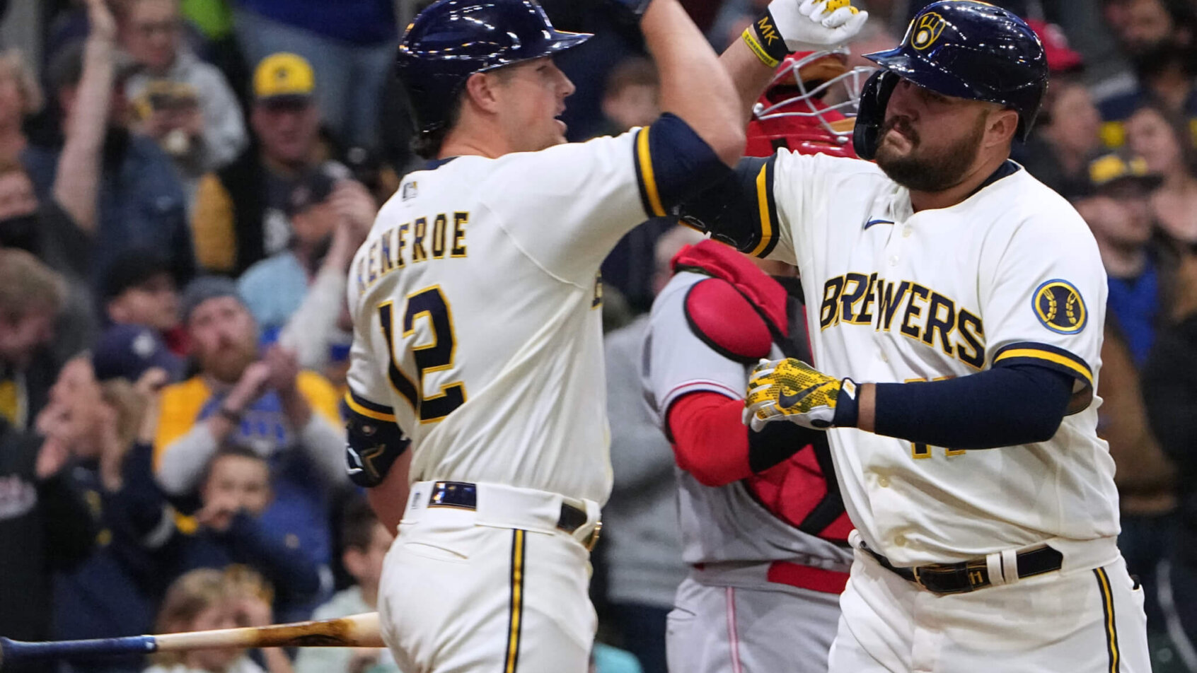 Milwaukee Brewers first baseman Rowdy Tellez celebrating with right fielder Hunter Renfroe