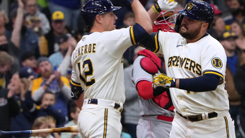 Milwaukee Brewers first baseman Rowdy Tellez celebrating with right fielder Hunter Renfroe