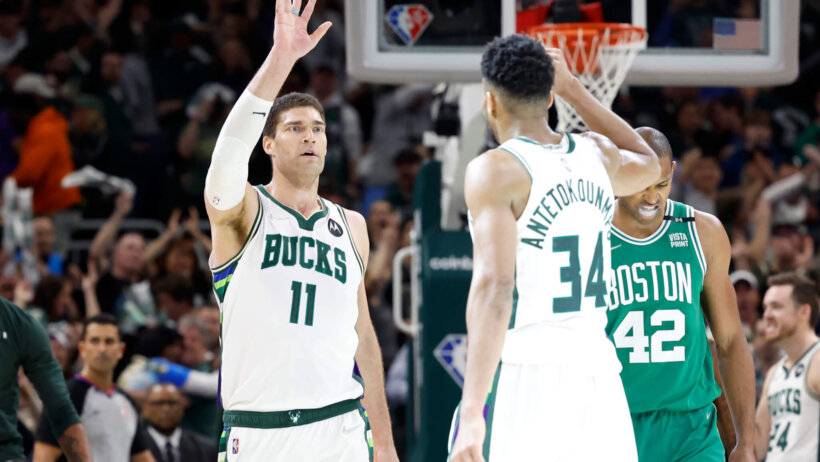 Milwaukee Bucks center Brook Lopez high-fiving forward Giannis Antetokounmpo