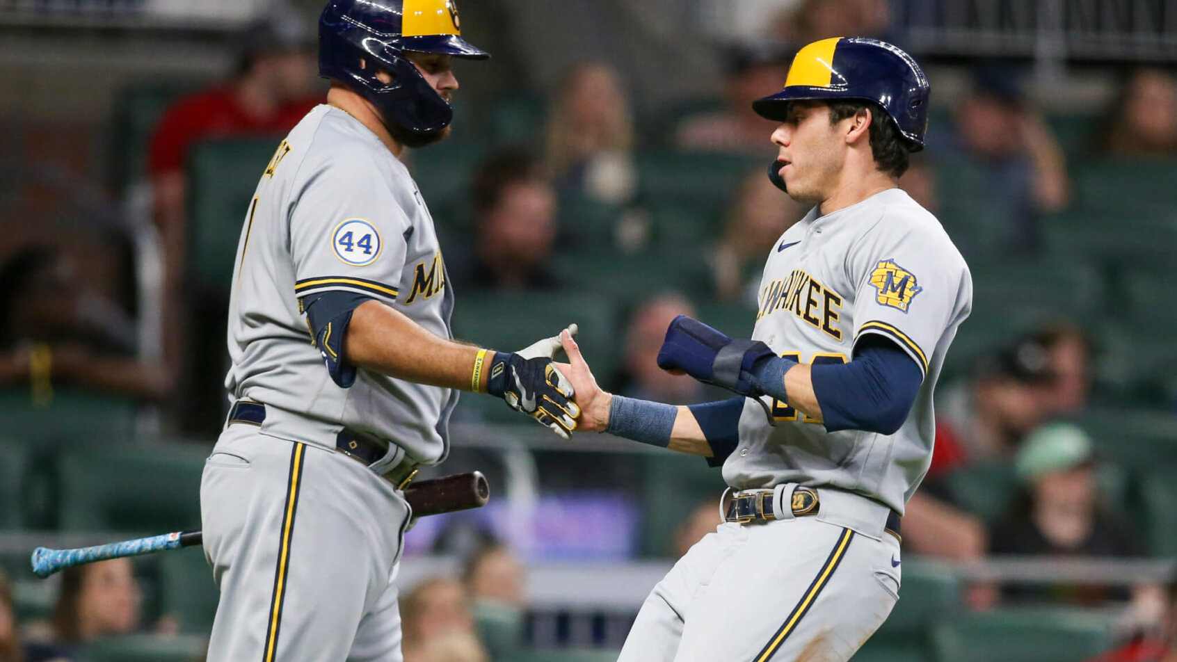 Milwaukee Brewers left fielder Christian Yelich celebrating a run with catcher Rowdy Tellez