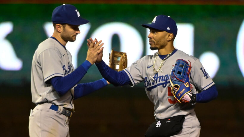 Los Angeles Dodgers shortstop Trea Turner and right fielder Mookie Betts high-fiving