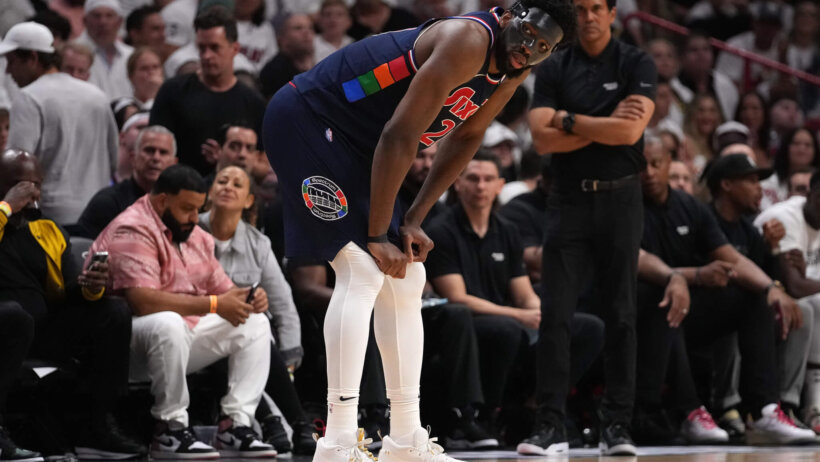 Joel Embiid bent over