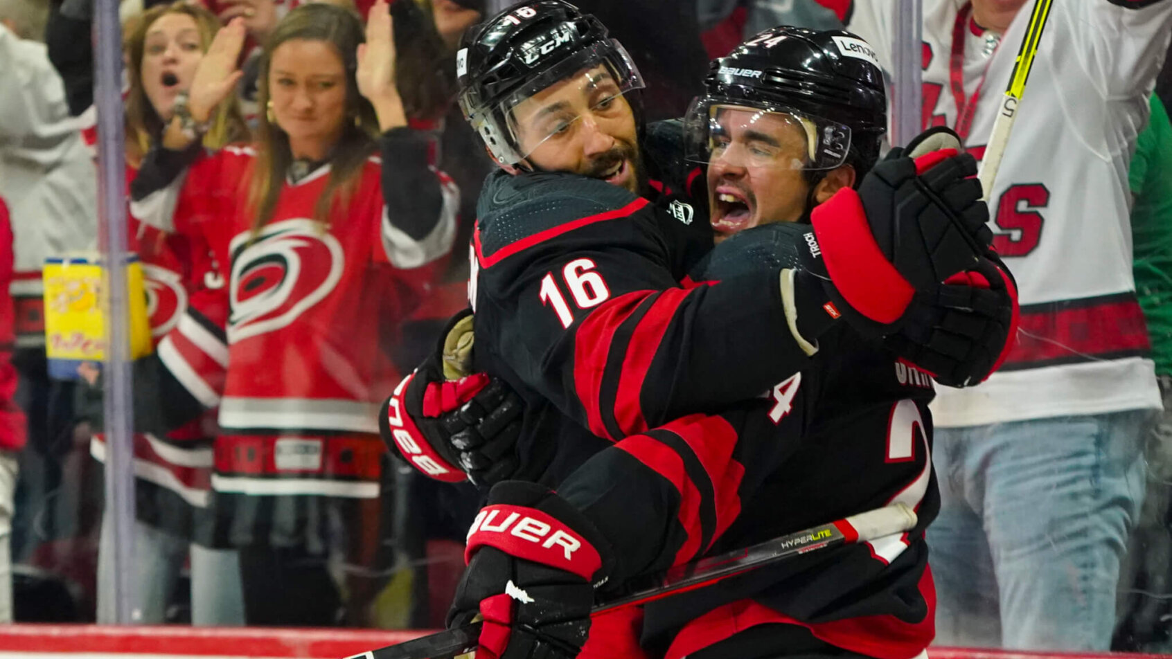 Carolina Hurricanes center Seth Jarvis celebrates with Vincent Trocheck