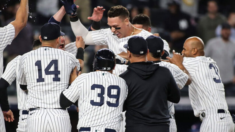 New York Yankees center fielder Aaron Judge is mobbed by teammates after a walk-off home run