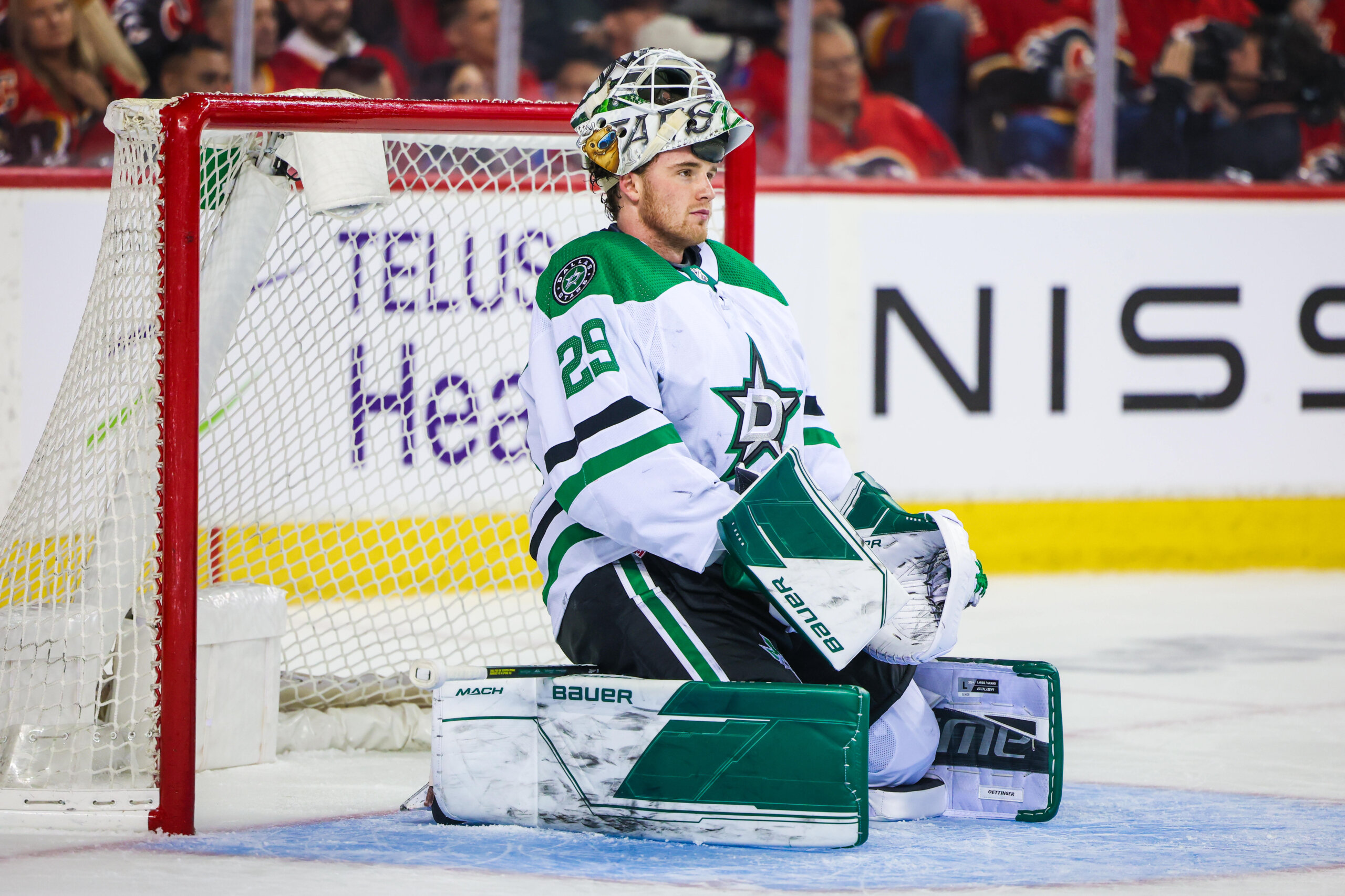 Dallas Stars goaltender Jake Oettinger kneeling on the ice