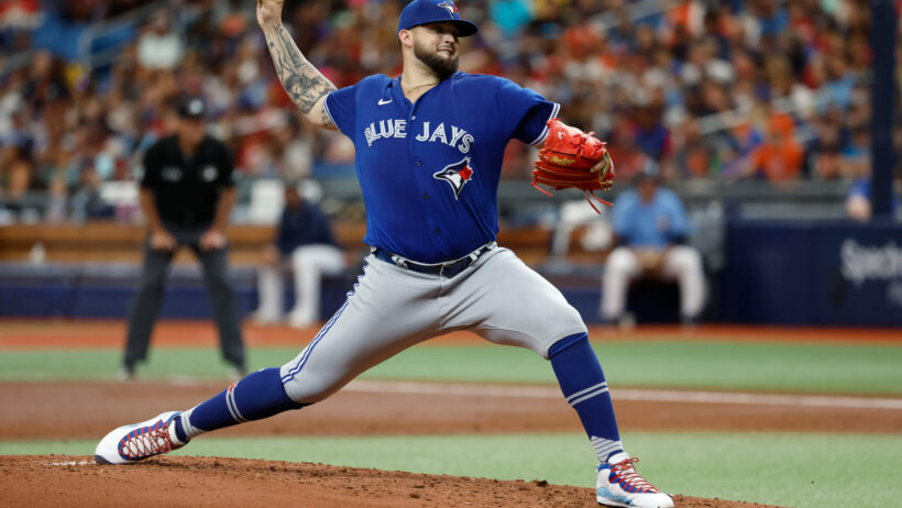 Alek Manoah throwing baseball Blue Jays jersey