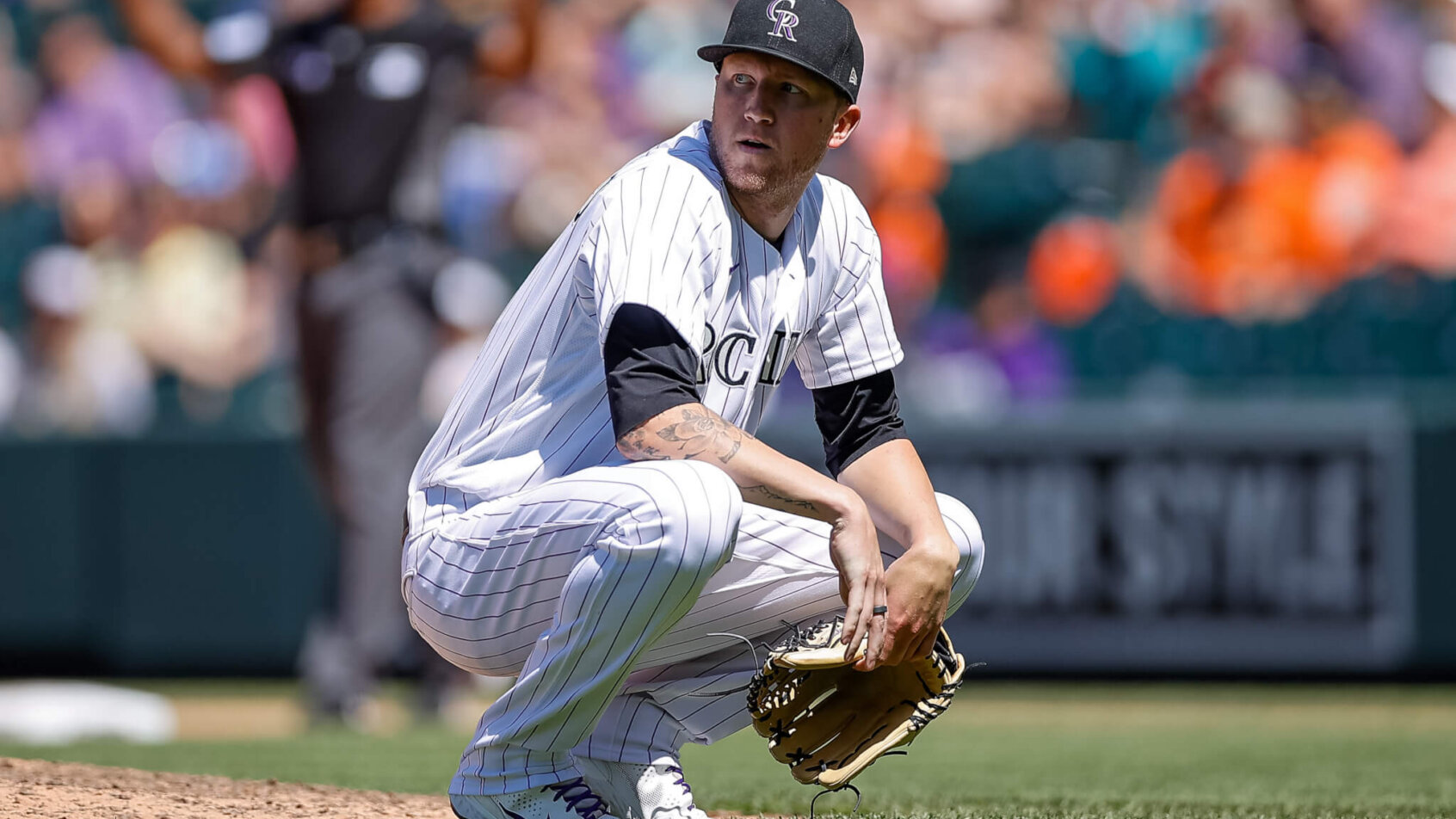 Colorado Rockies starting pitcher Kyle Freeland squatting on the field