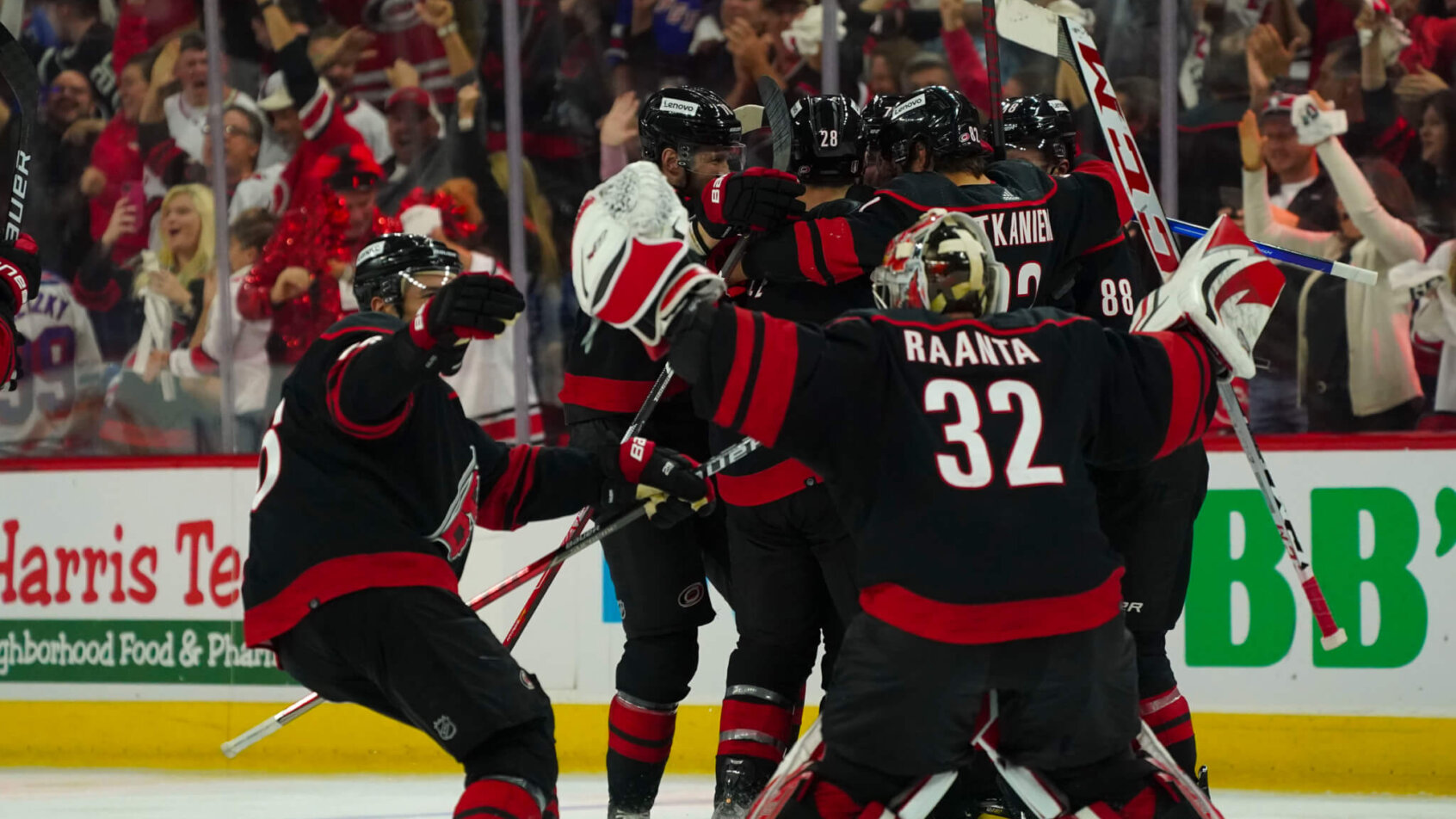 Carolina Hurricanes players celebrate an OT win against the New York Rangers