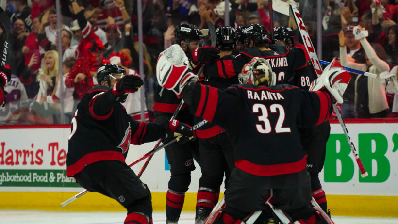 Carolina Hurricanes players celebrate an OT win against the New York Rangers