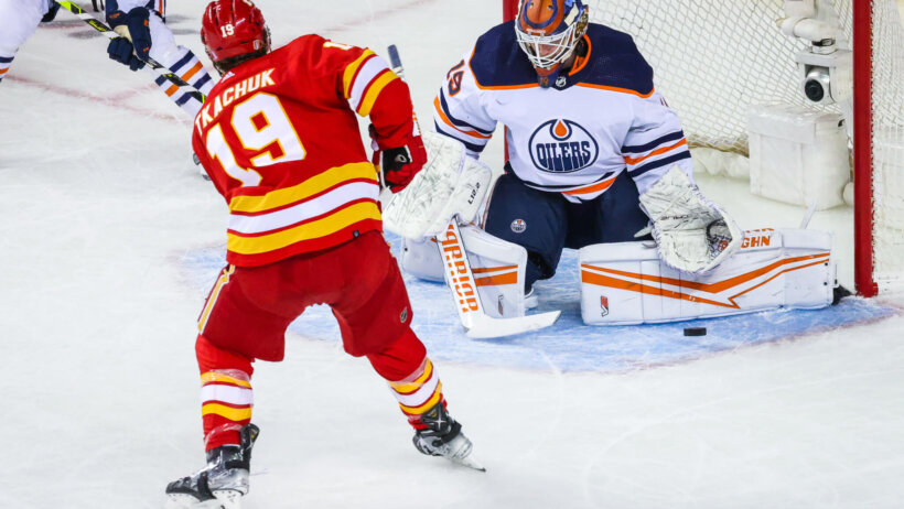 Edmonton Oilers goaltender Mikko Koskinen making a save of Calgary Flames forward Matthew Tkachuk