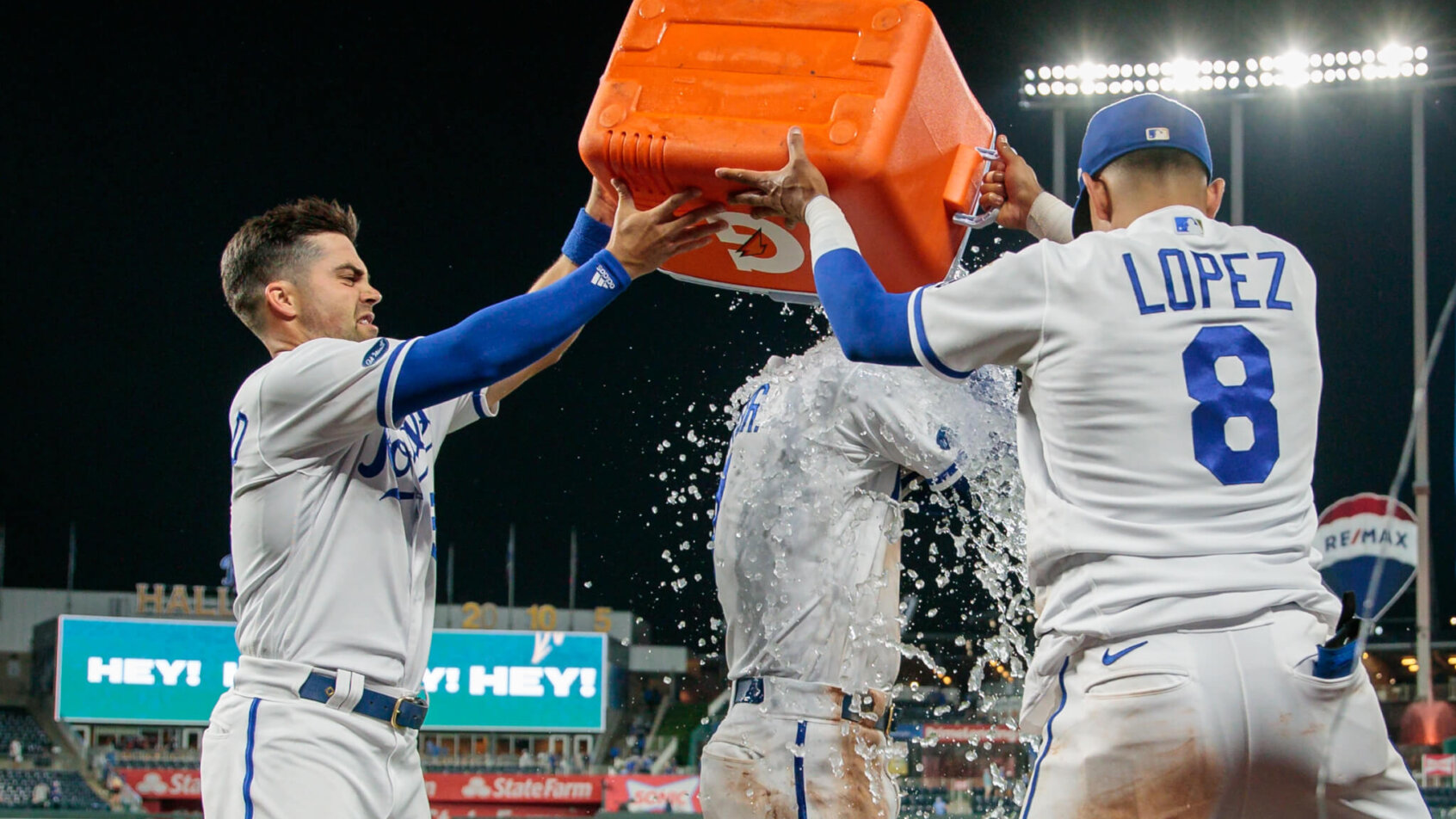Kansas City Royals Whit Merrifield and Nicky Lopez dumping water on Bobby Witt Jr