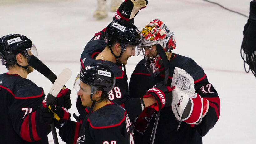 Carolina Hurricanes goaltender Antti Raanta congratulated by teammates after a win