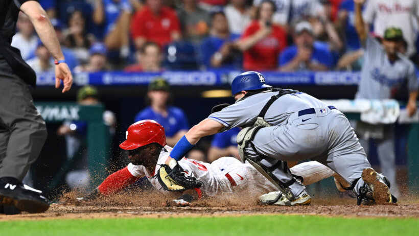 Los Angeles Dodgers catcher Will Smith tagging Philadelphia Phillies outfielder Odubel Herrera at home plate